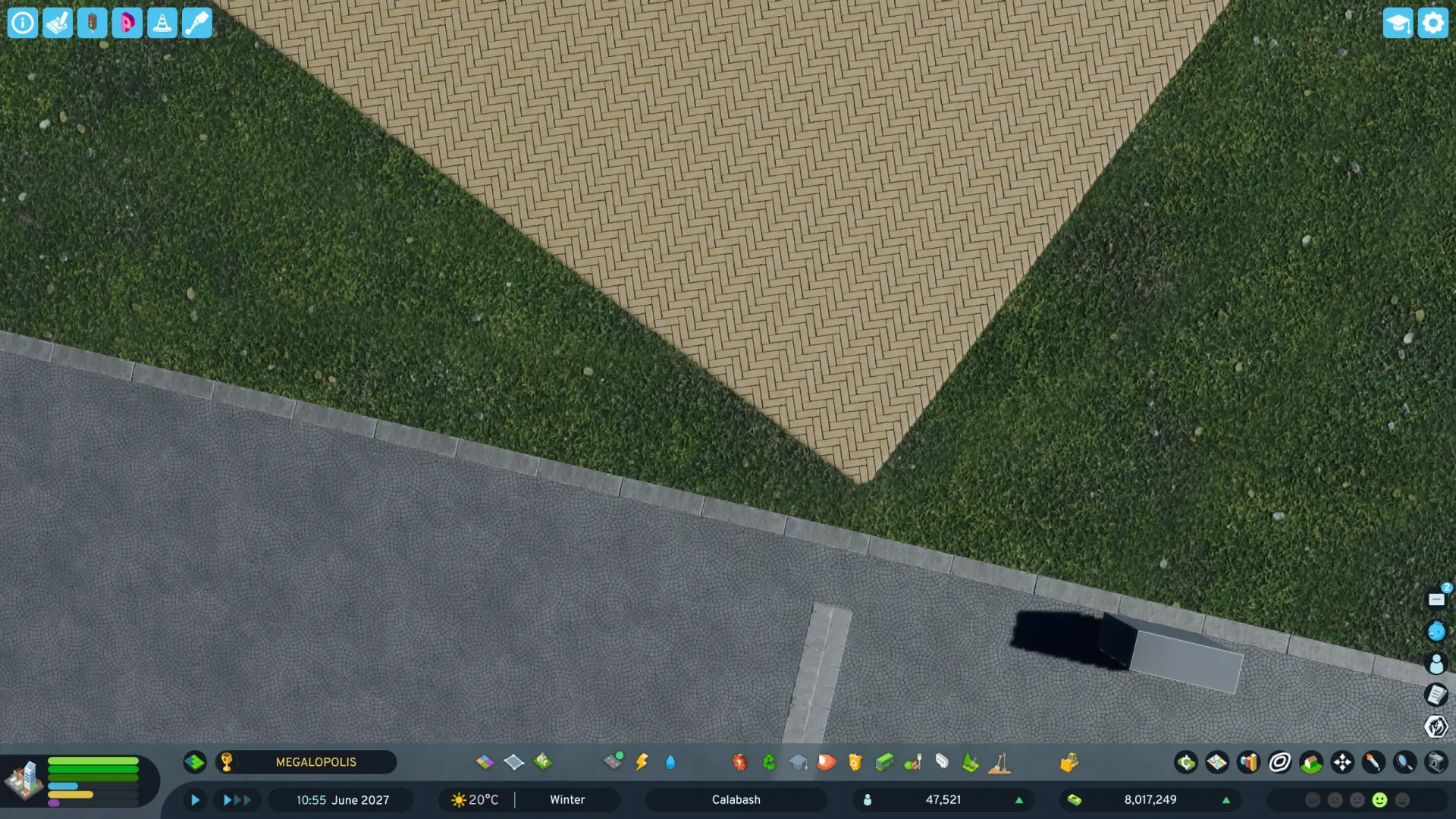 In-game screenshot of Cities: Skylines 2 showing rigid, perfectly straight square seams where sidewalk, grass, and building tiles meet.